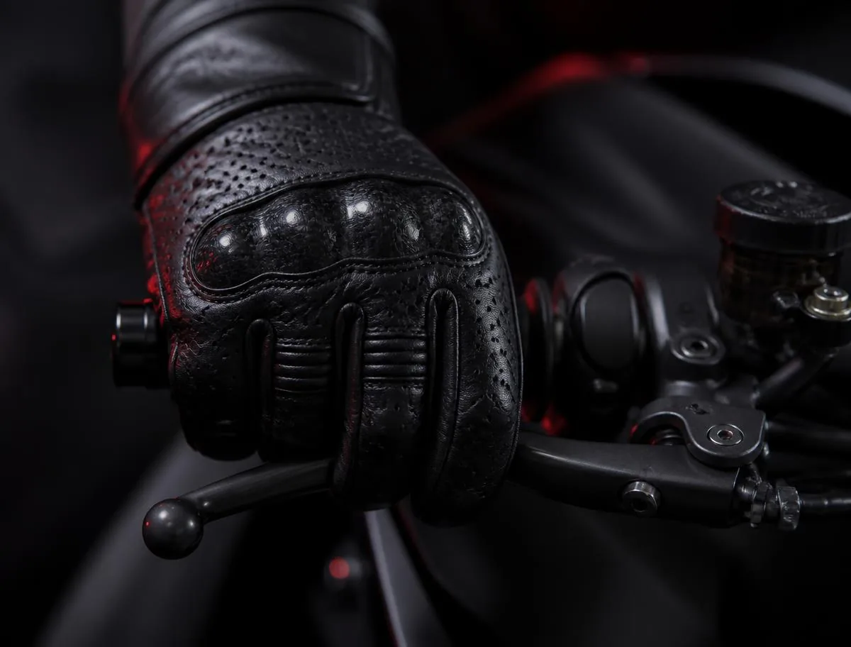 Rider's hands on the clutch lever and handlebars during motorcycle training